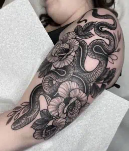 Blackwork Snake and Flowers Tattoo