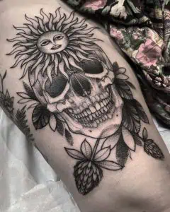 Skull and Sun Black Work Tattoo