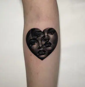 Faces in a heart shape tattoo