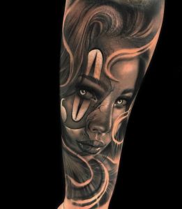 Realistic black and grey woman face tattoo