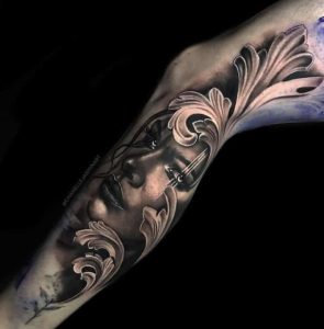 Black and grey tattoo on a leg