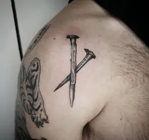 Two nails engraving tattoo
