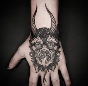 Devils face etching tattoo