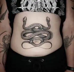 Two snakes engraving tattoo