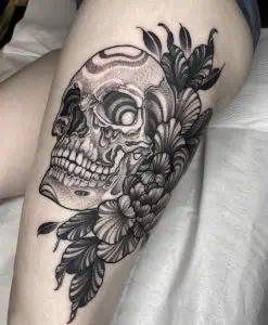 Skull and flowers dotwork tattoo