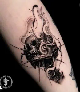 Skull tattoo with spikes and abstract elements, black and grey ink