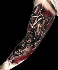Japanese tattoo featuring a sword and body tattooed on arm