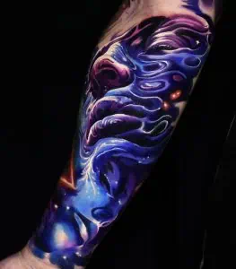 Cosmic fantasy colour tattoo on an arm